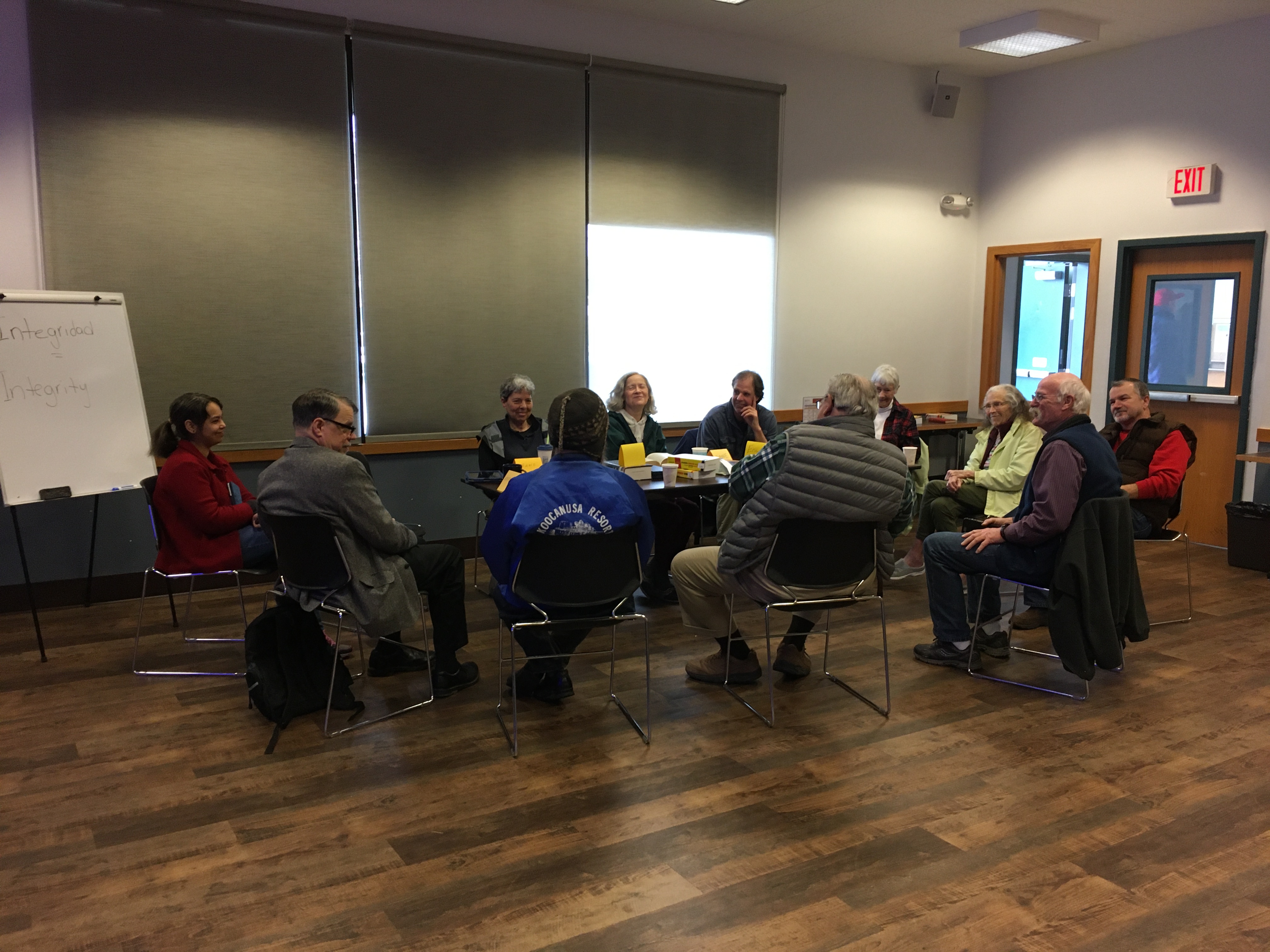 Spanglish group sitting around table conversing